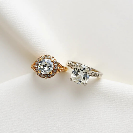 Vintage style moissanite rings with halo and milgrain settings on a neutral background