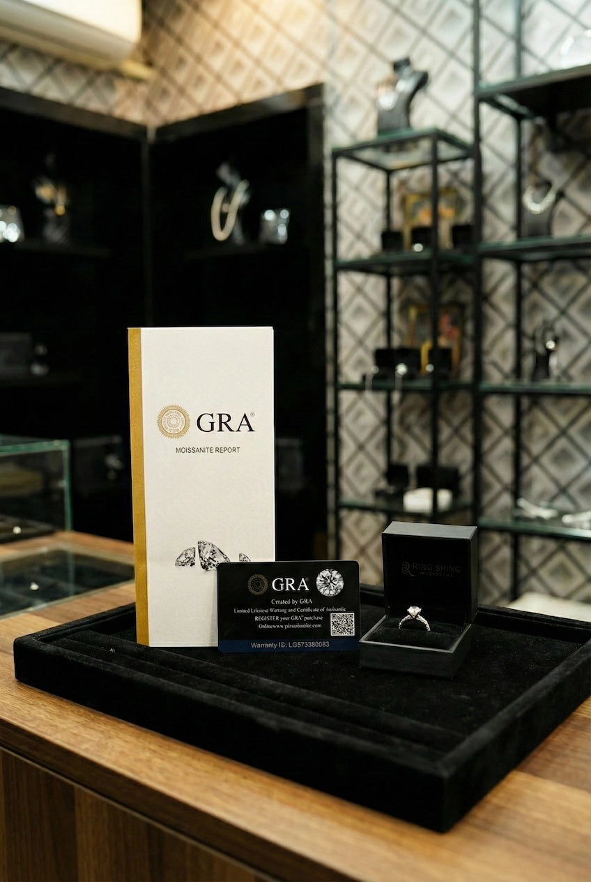 GRA jewelry packaging and display on a wooden surface with a decorative background